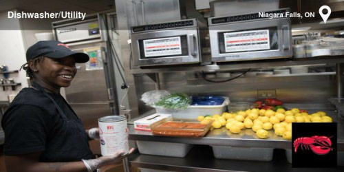 A female Red Lobster employee holds a large can in front of a preparation table covered in lemons in the Red Lobster kitchen.